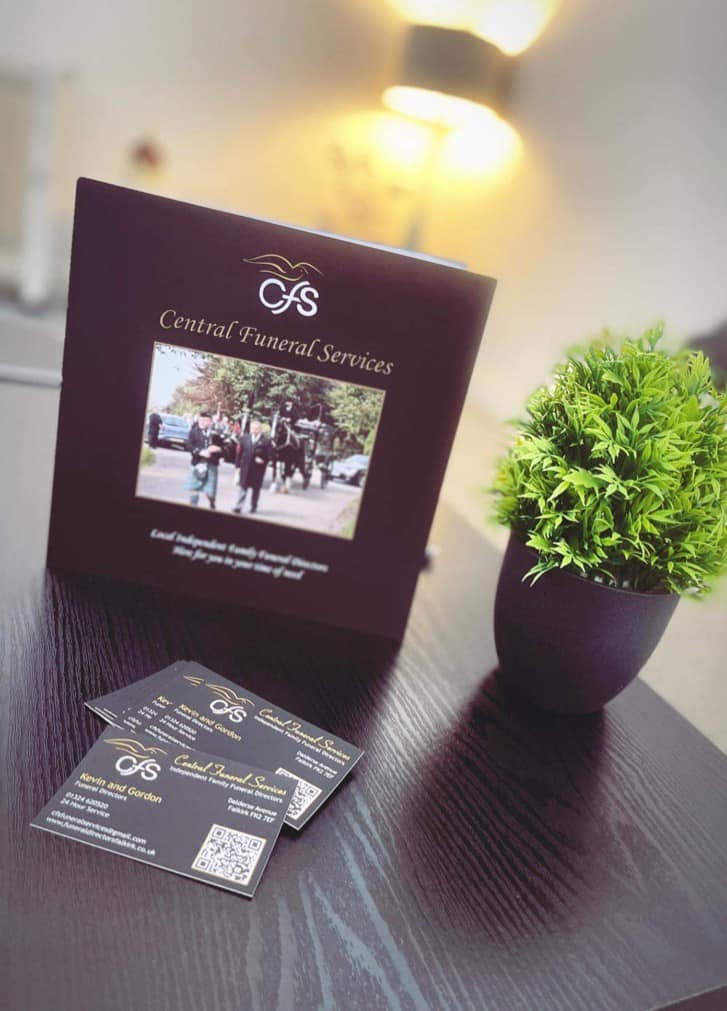 Central Funeral Services brochure on a table with small plant