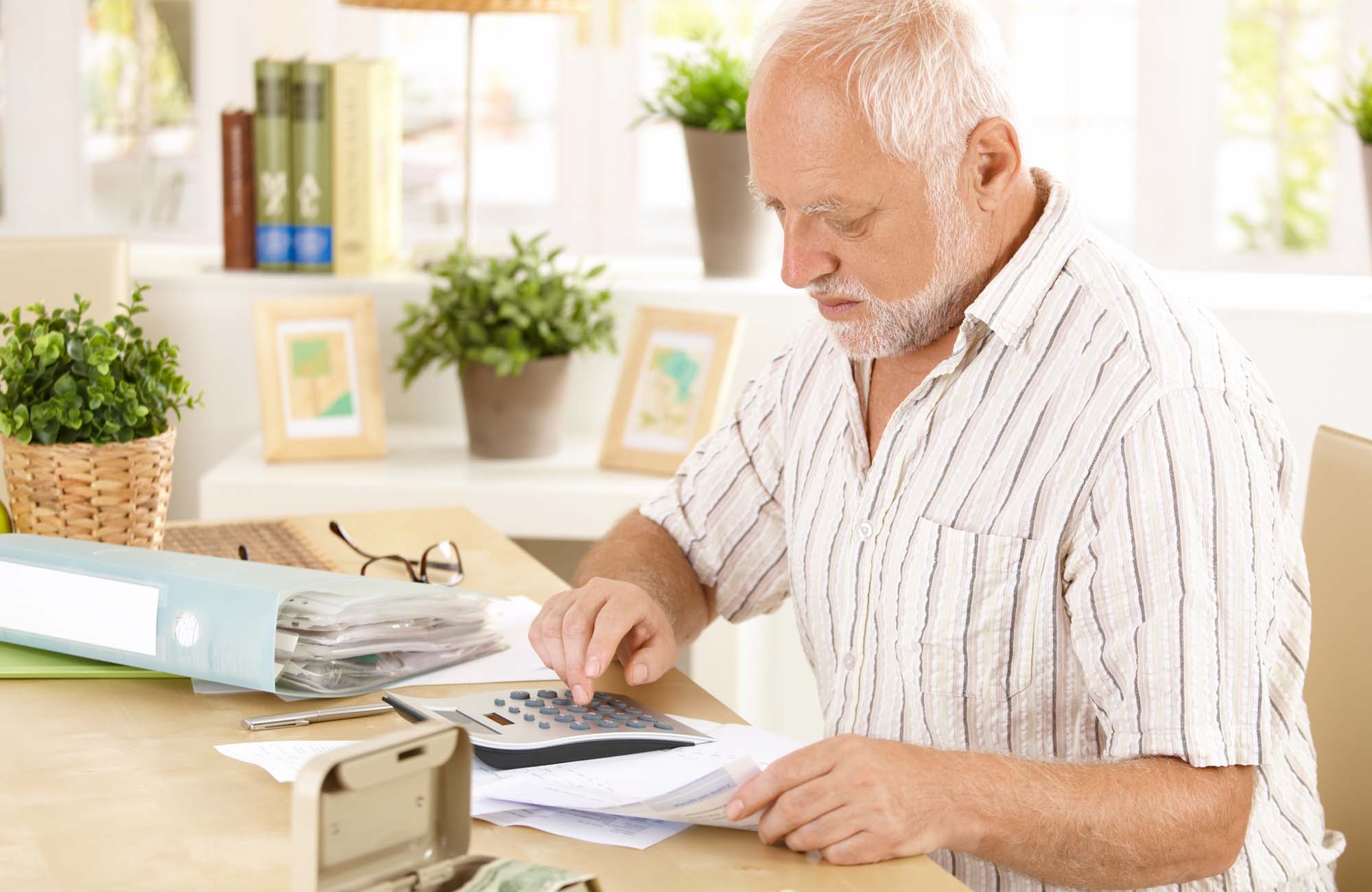 Elderly man working on figures