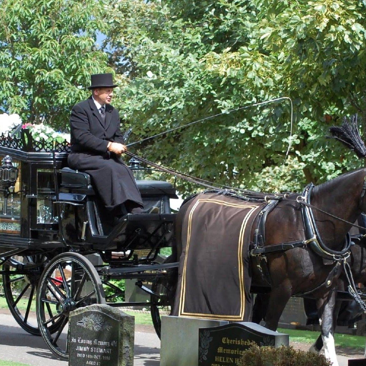 Man on horse drawn carriage with coffin in Falkirk