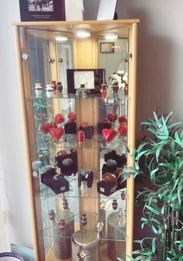 urns in glass cabinet - Central Funeral Services