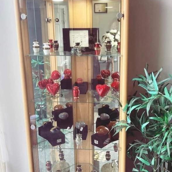 urns in glass cabinet - Central Funeral Services