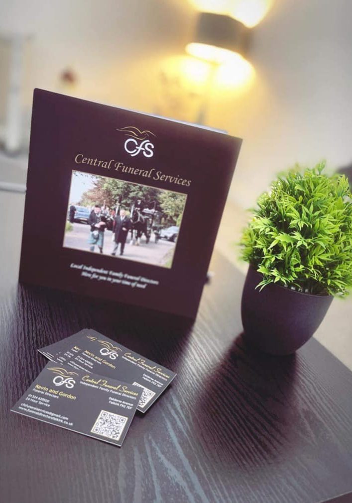 Central Funeral Services brochure on a table with small plant