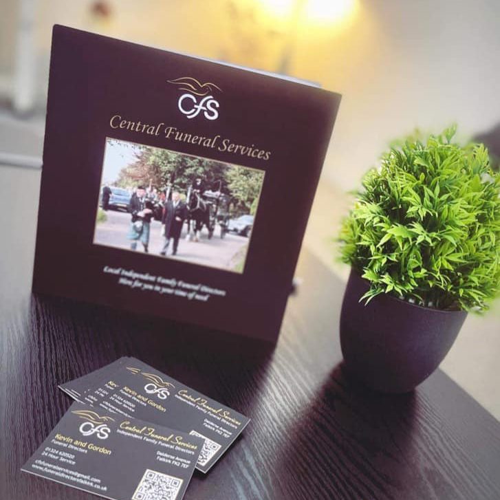 Central Funeral Services brochure on a table with small plant