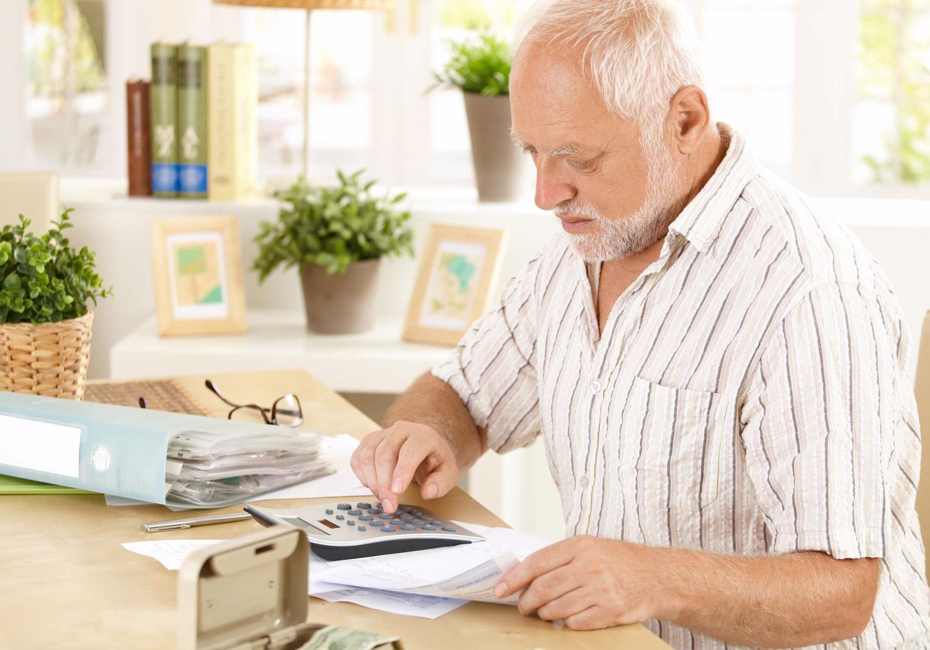 Elderly man working on figures