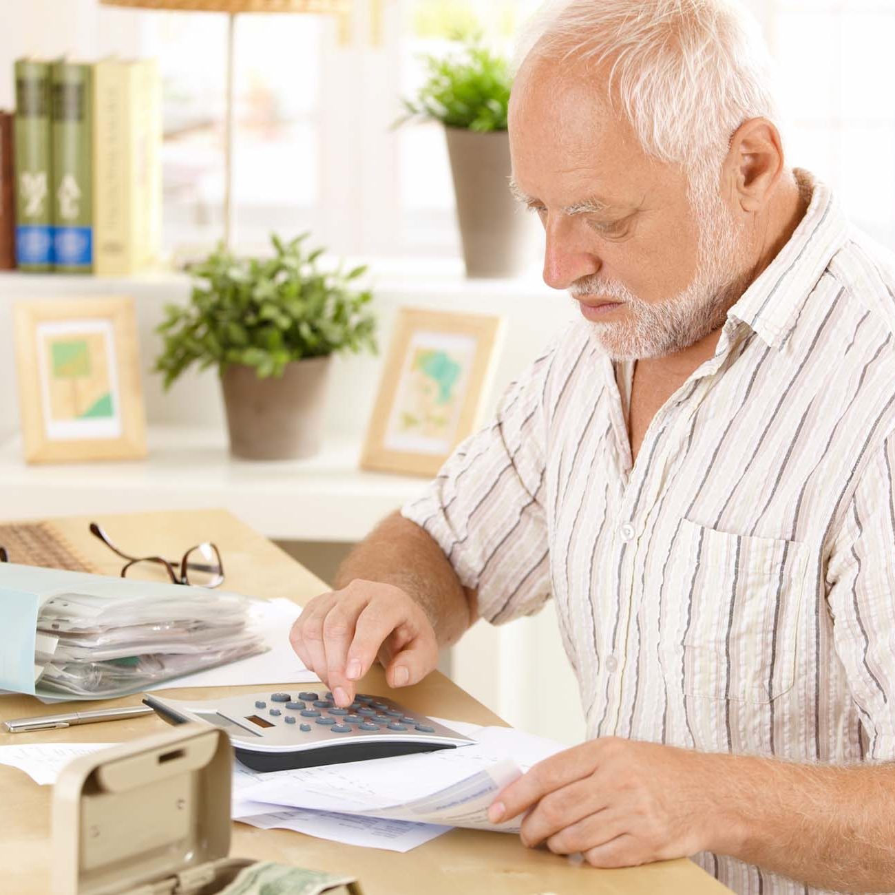 Elderly man working on figures