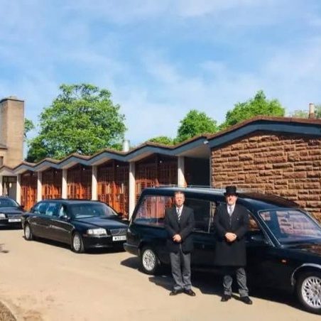 2 men standing outside a funeral directors in Falkirk